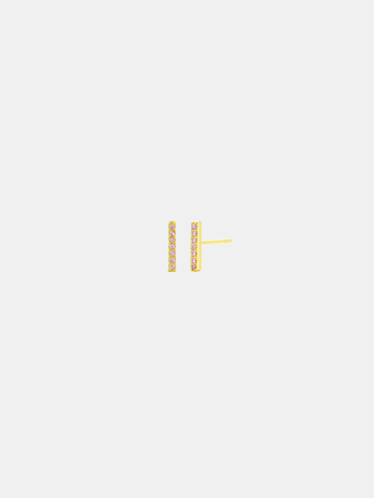 Gold birthstone earring on a light gray background