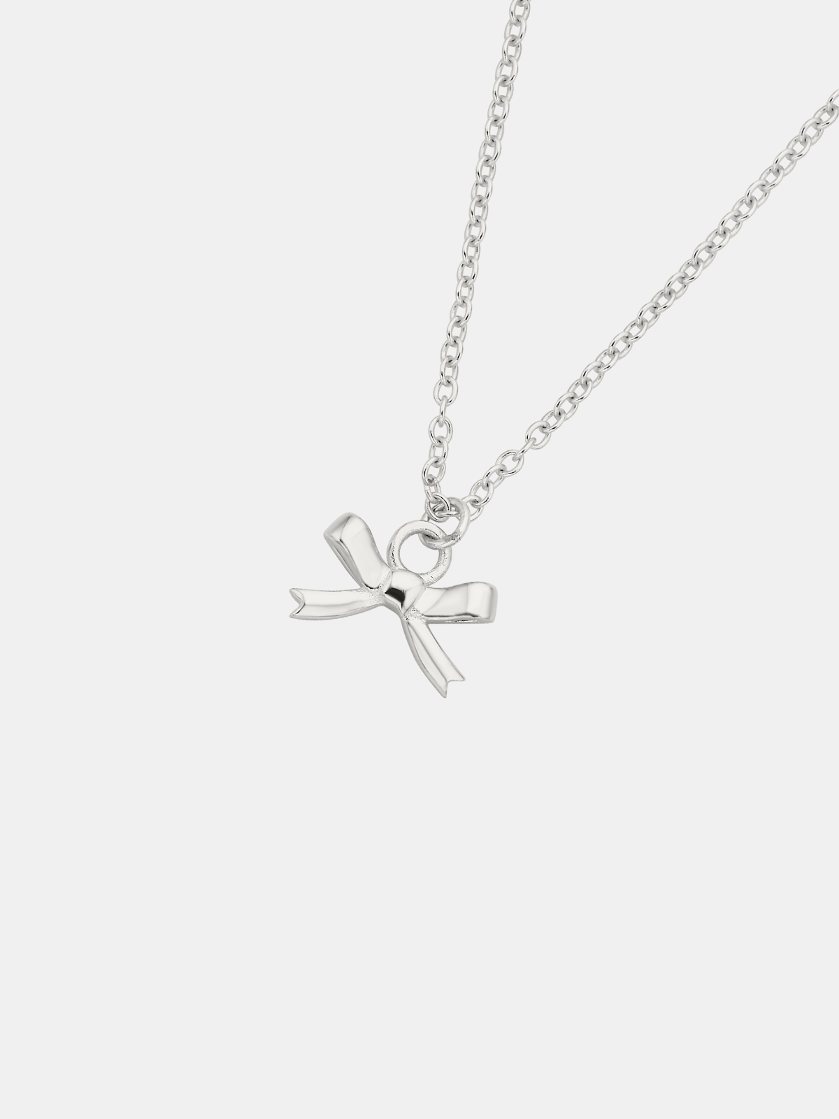 Silver necklace with a bow pendant on a white background