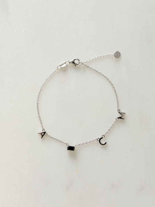 Silver choose your letters bracelet on a light gray background