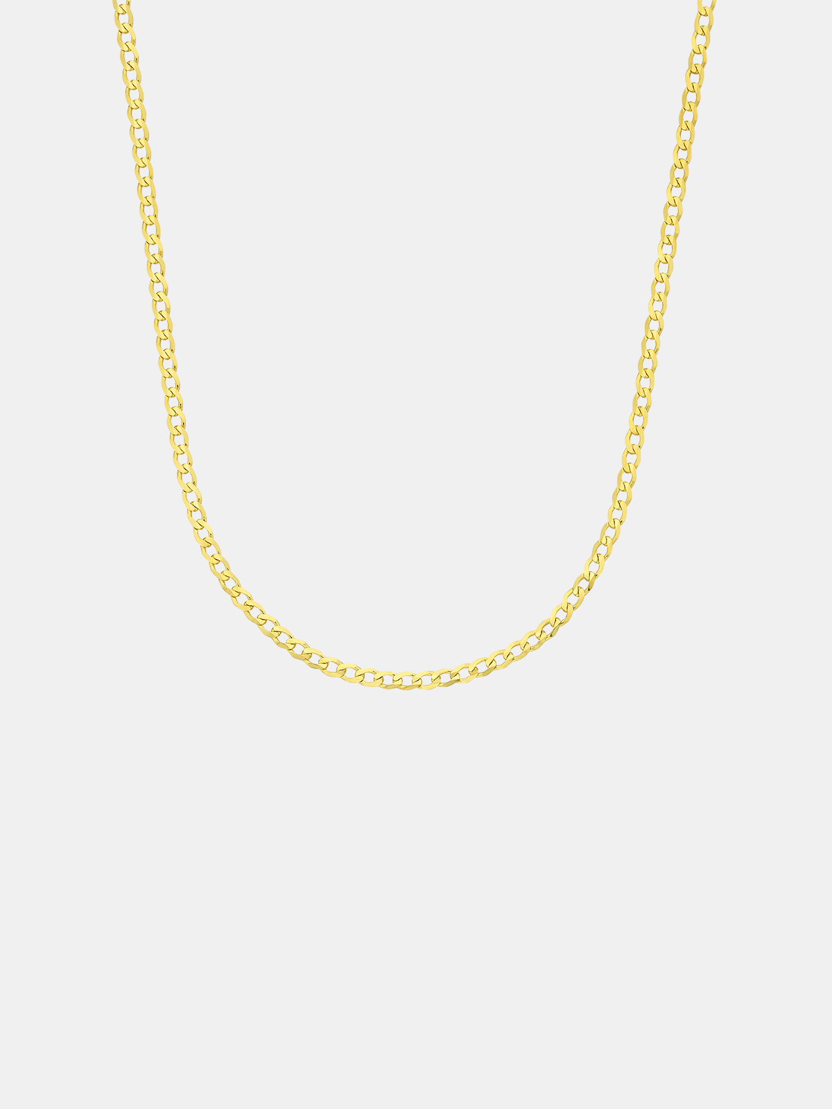 Gold chain necklace on a light gray background