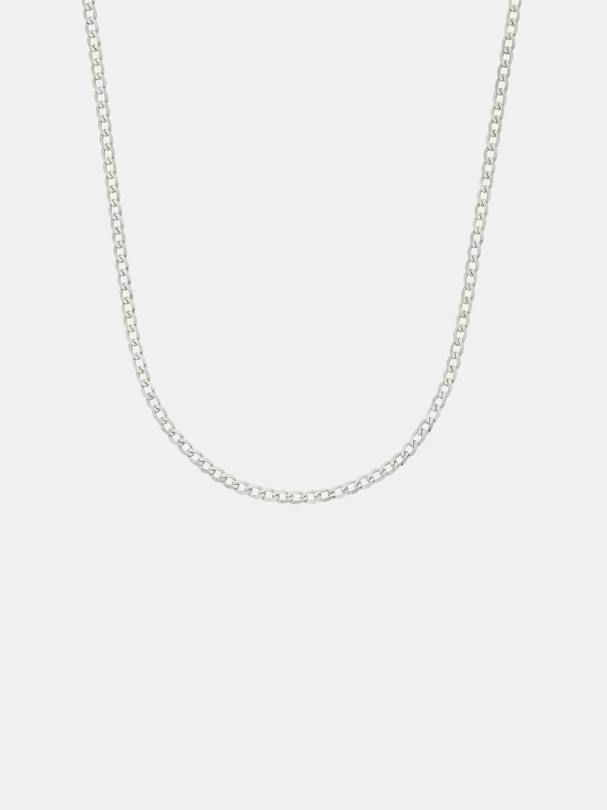 Silver chain necklace on a light gray background