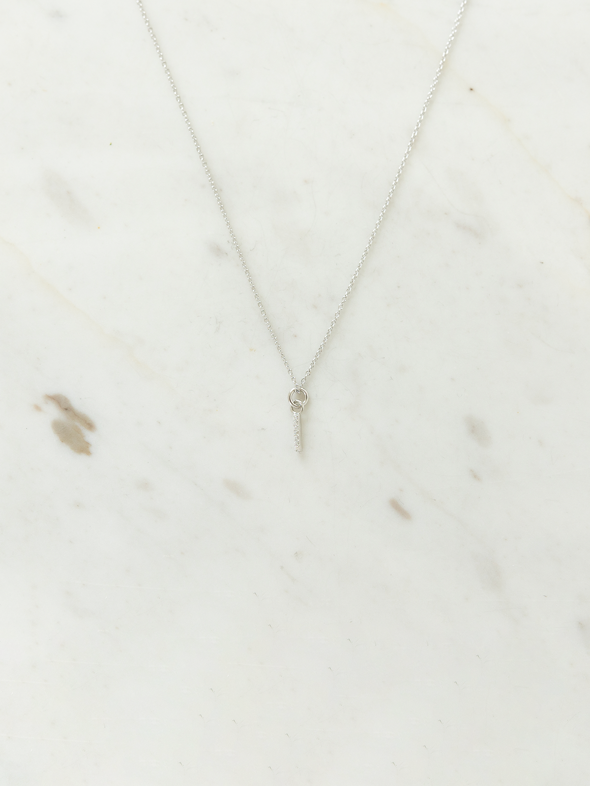 Silver necklace on a marble surface