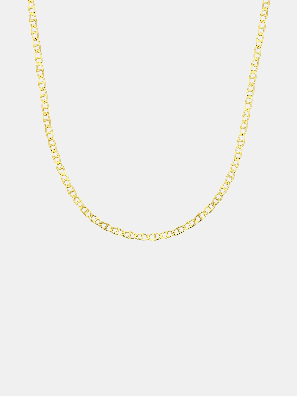 Gold chain necklace on a light gray background
