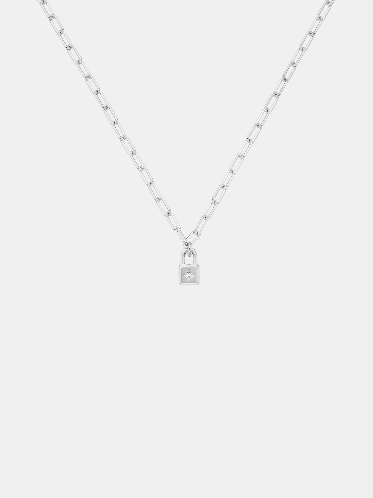 Silver necklace with a lock pendant on a white background