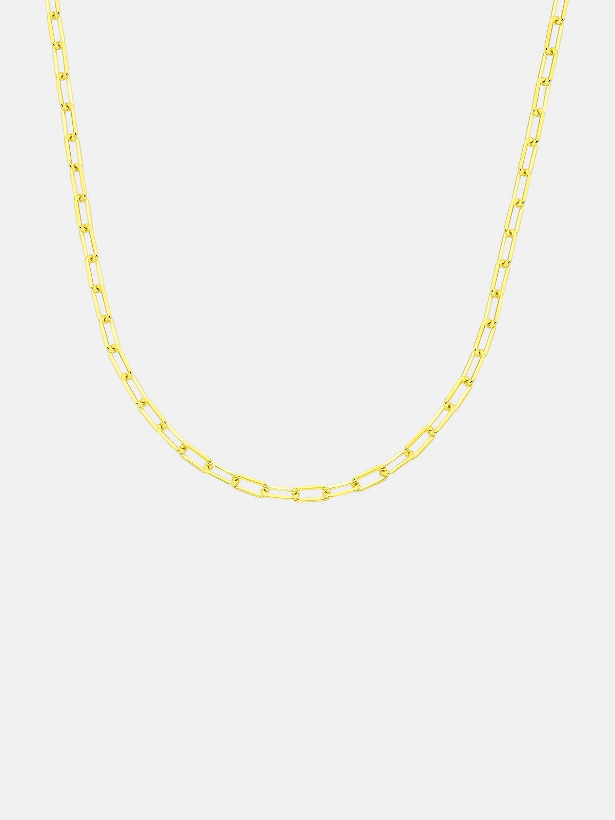 Gold chain necklace on a light gray background