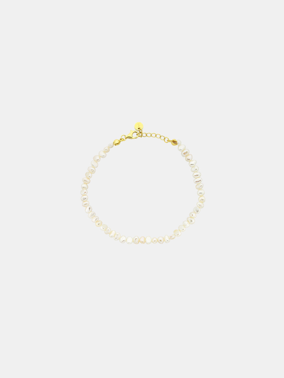 Mini pearl bracelet for kids on a light gray background
