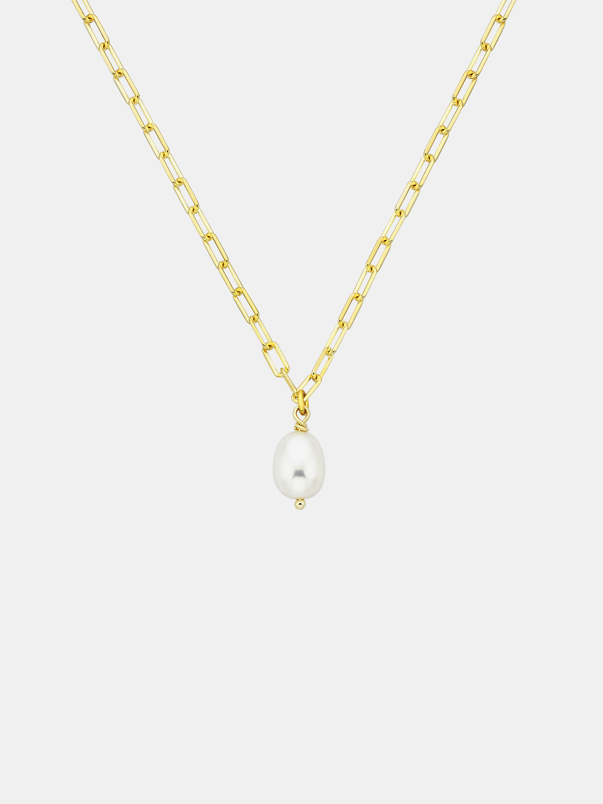 Gold chain necklace with a single pearl pendant on a light gray background