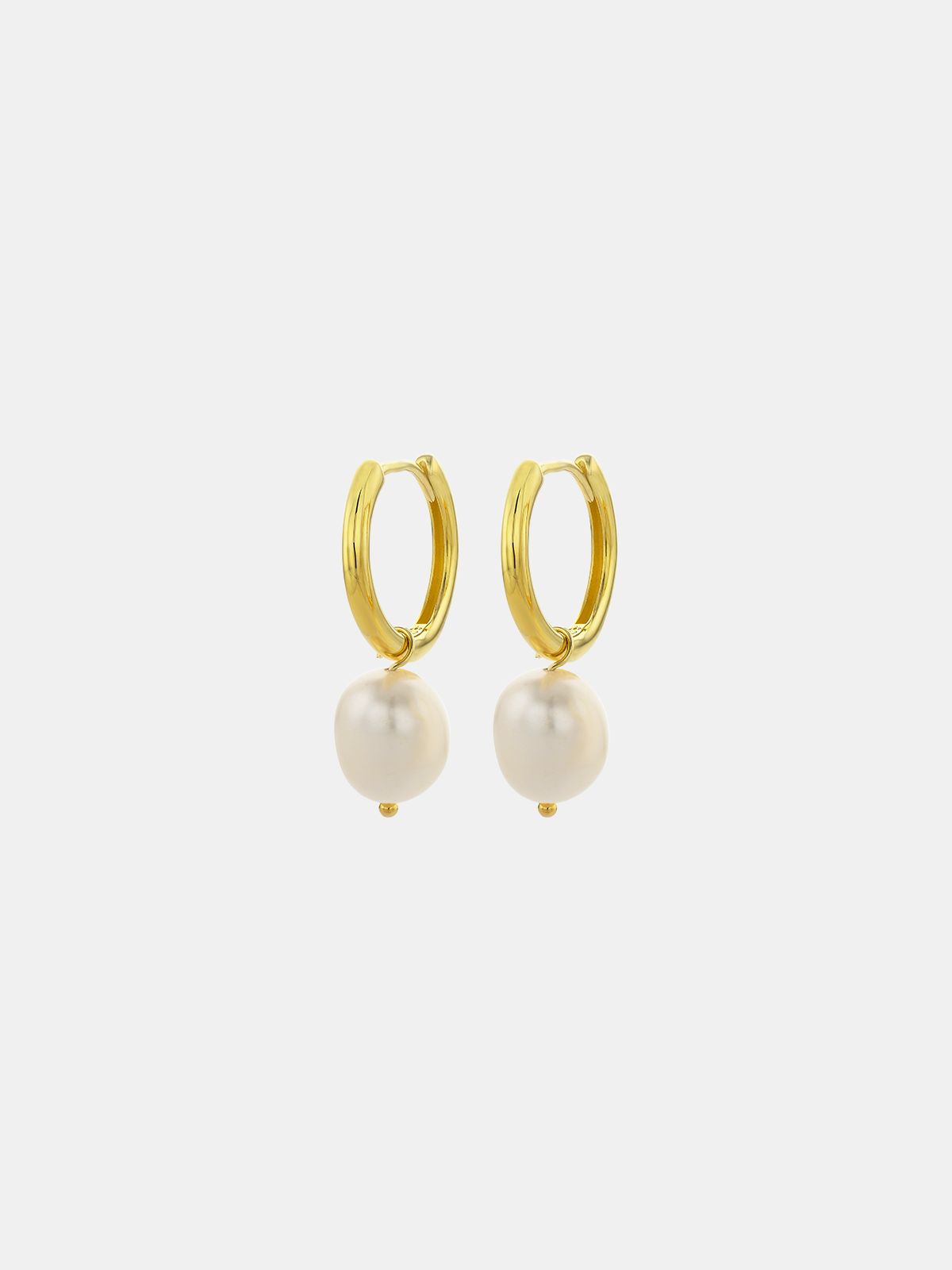 Gold hoop earrings with pearls on a white background