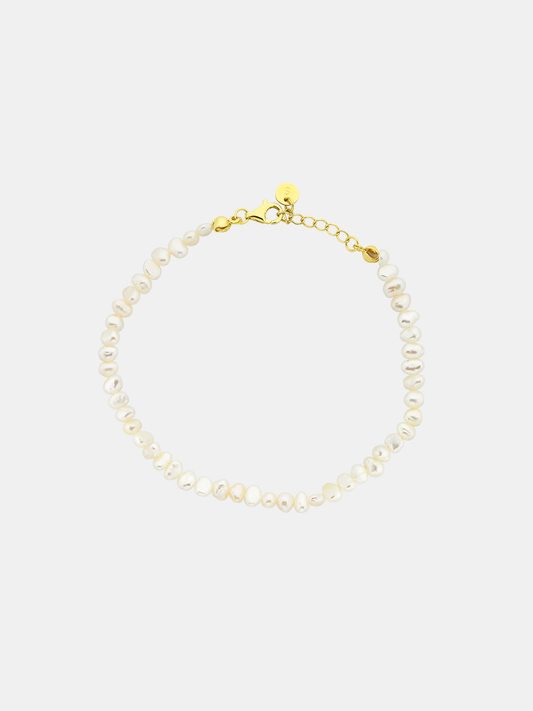 Pearl anklet with gold clasp on a white background