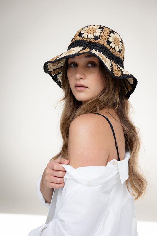woman in crochet hat with white shirt