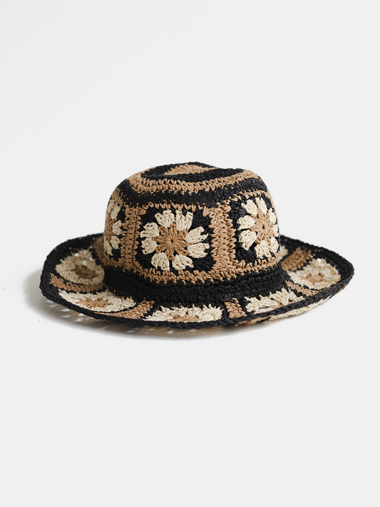 Crocheted hat with floral pattern on a white background