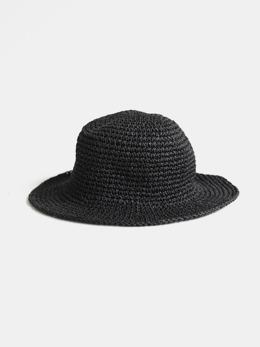 Black woven hat on a light gray background