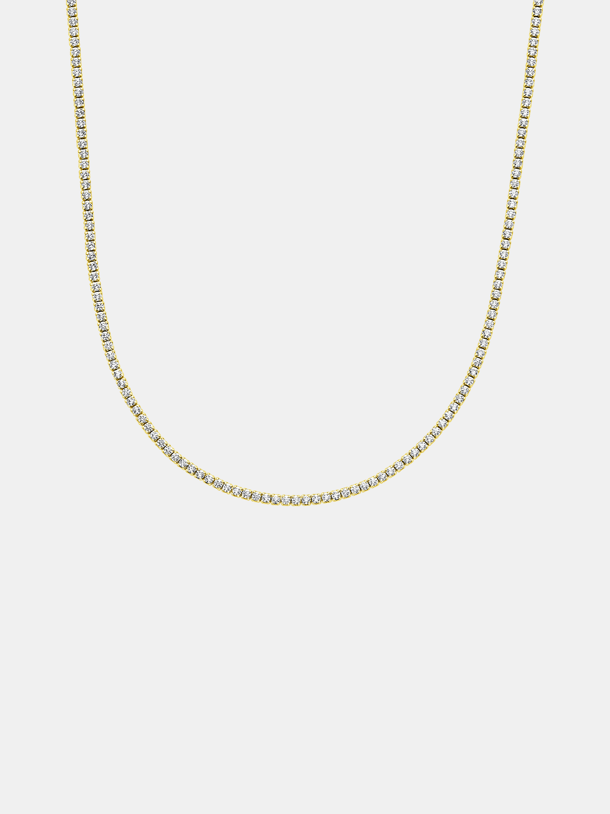 Gold tennis chain necklace on a light gray background