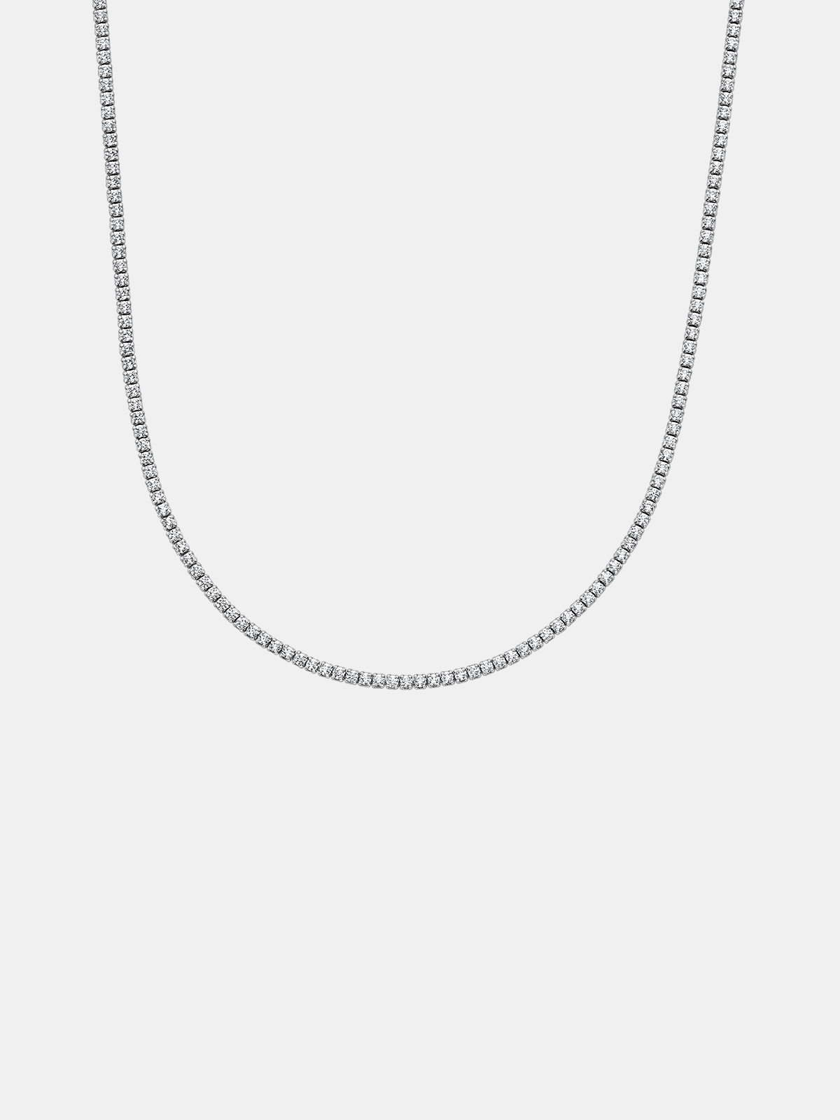Silver tennis chain necklace on a light gray background