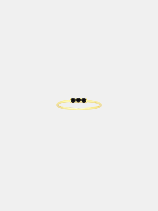 Gold ring with three black stones on a white background
