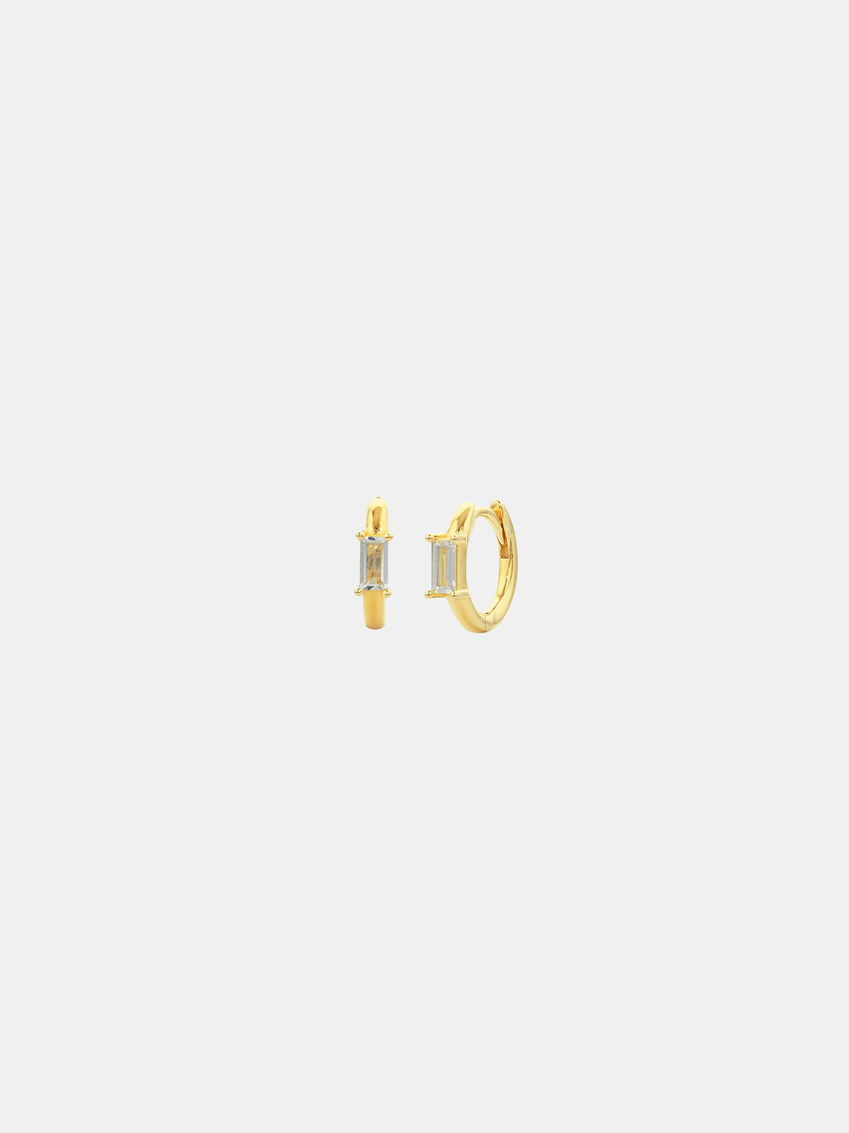 Gold hoop earrings on a light gray background