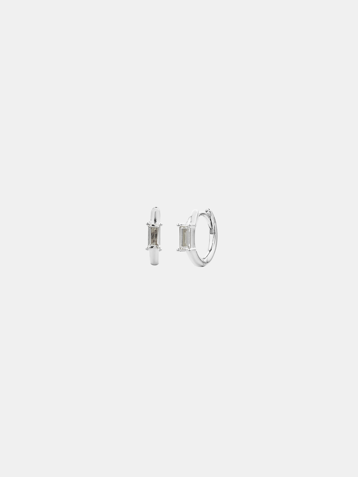 Pair of silver hoop earrings on a light gray background