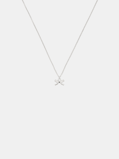 Silver necklace with a bow pendant on a white background