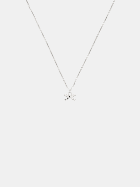 Silver necklace with a bow pendant on a white background