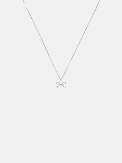 Silver necklace with a bow pendant on a white background
