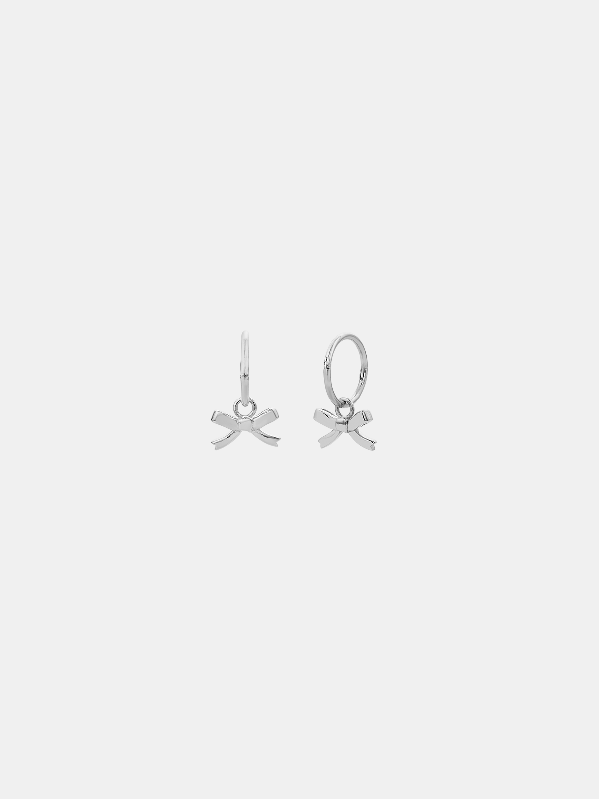 Pair of silver earrings on a light gray background