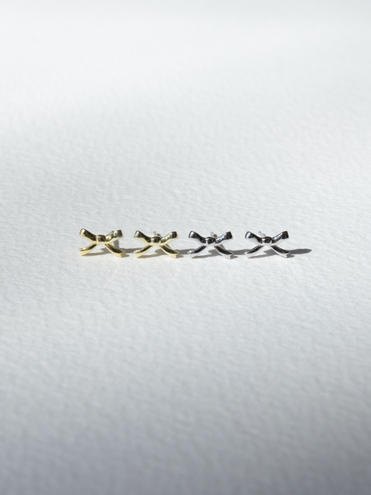 Gold and silver earrings  on a light grey background