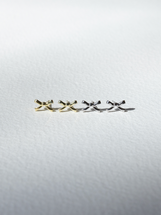 Gold and silver earrings  on a light grey background