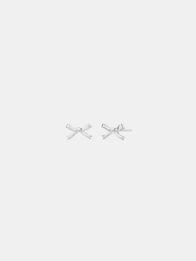 Pair of silver bow-shaped earrings on a light gray background