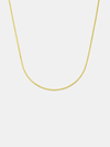 Gold chain necklace on a light gray background