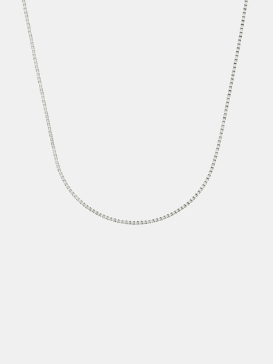 Silver box chain necklace on a light gray background