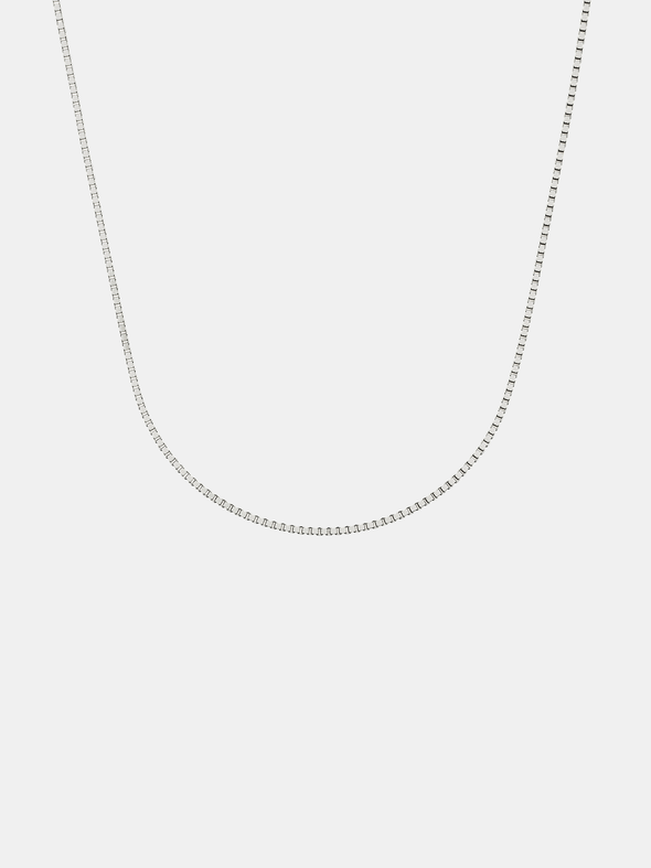 Silver box chain necklace on a light gray background