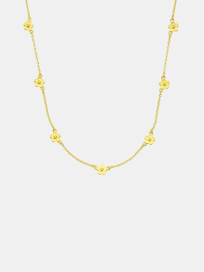 Gold necklace with floral pendants on a white background