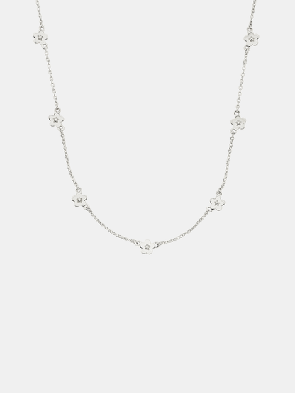 Silver necklace with small floral pendants on a white background
