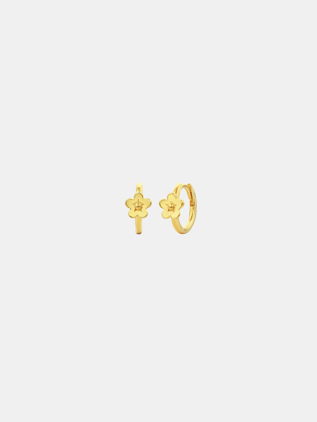 Gold hoop earrings with floral designs on a white background