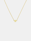Solid gold necklace with a small daisy day flower pendant on a light grey background