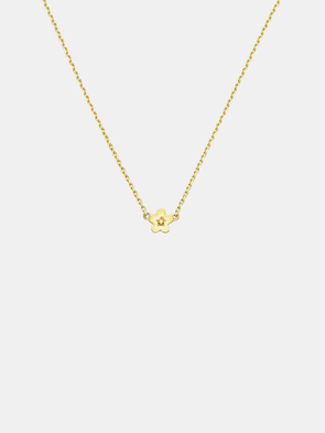 Solid gold necklace with a small daisy day flower pendant on a light grey background