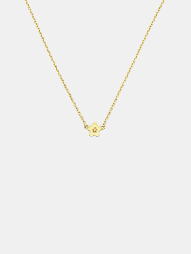Solid gold necklace with a small daisy day flower pendant on a light grey background