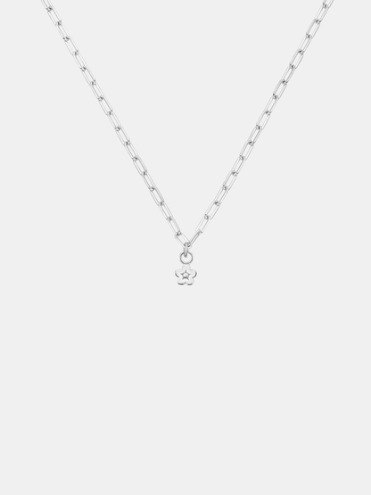 Gold necklace with a daisy day flower pendant on a light gray background