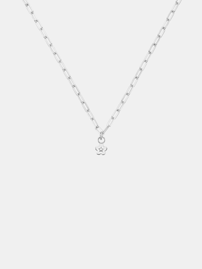 Gold necklace with a daisy day flower pendant on a light gray background