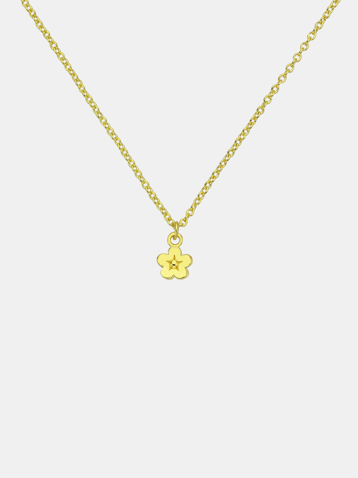 Gold necklace with a small flower pendant on a white background
