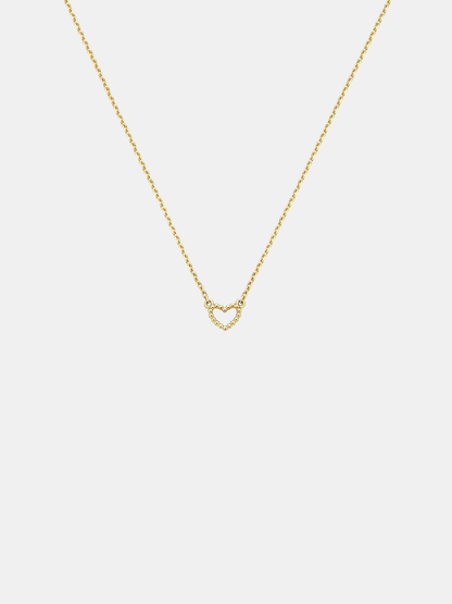 Solid gold dotty love heart-shaped pendant necklace on a light gray background