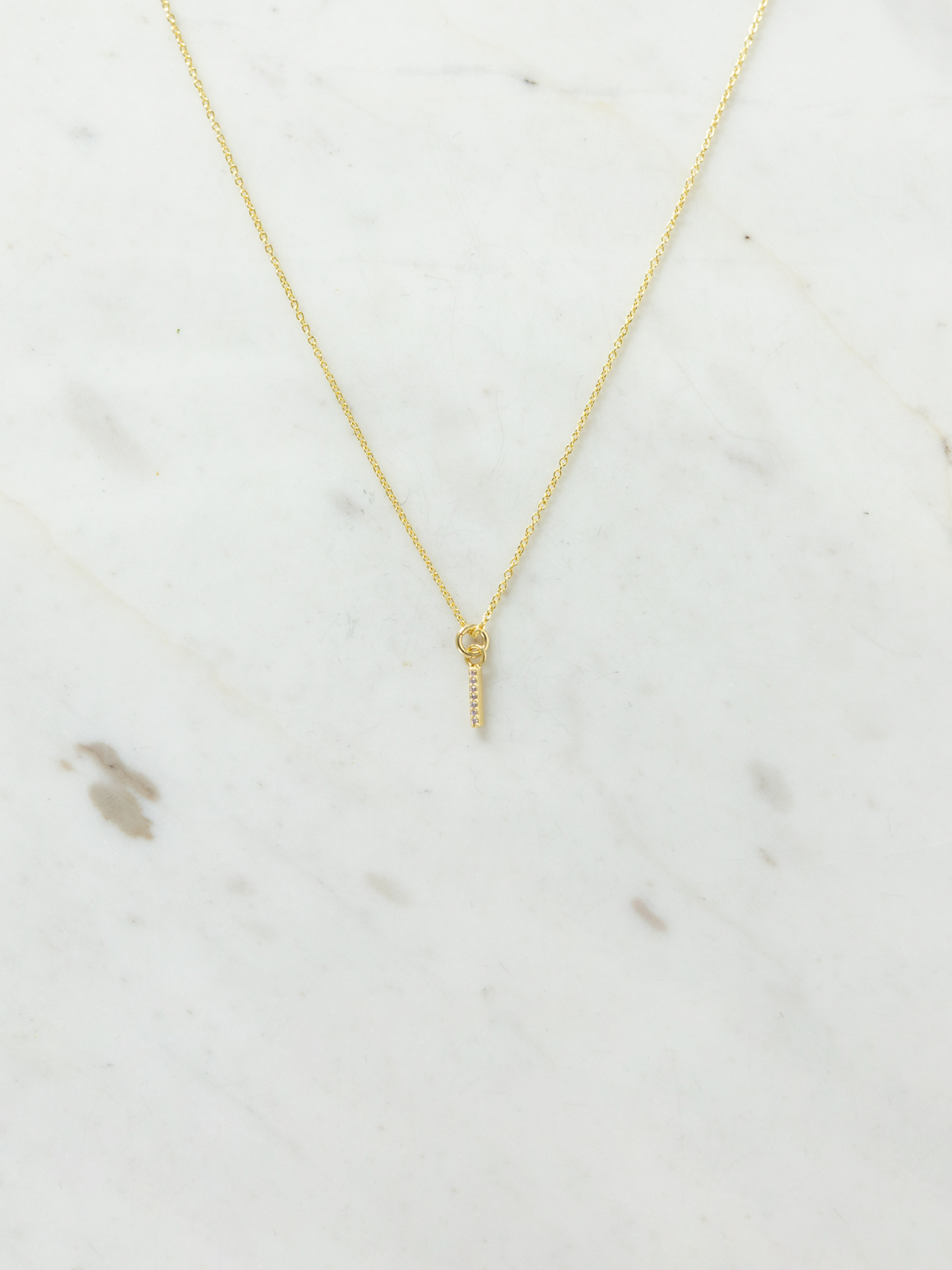 Gold necklace on a marble surface