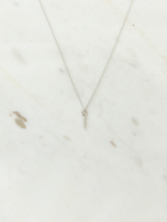 Silver necklace on a marble surface