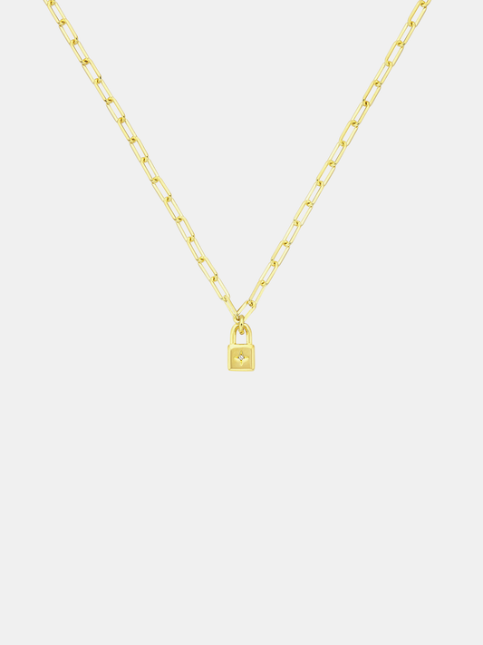 Gold necklace with a lock-shaped pendant on a light gray background