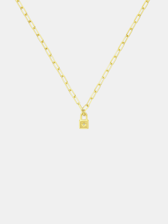 Gold necklace with a lock-shaped pendant on a light gray background