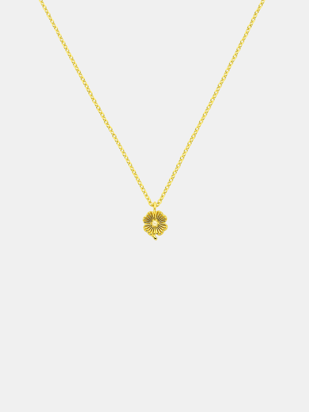 Gold necklace with a lily pendant featuring small pearl on a white background