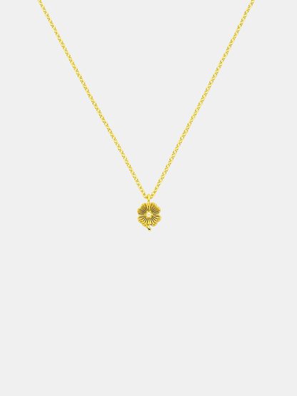 Gold necklace with a lily pendant featuring small pearl on a white background
