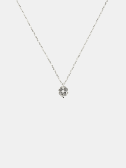 Silver necklace with a lily  pendant with small pearl on a light gray background