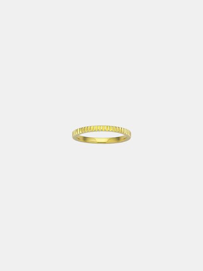Gold ring on a light beige background