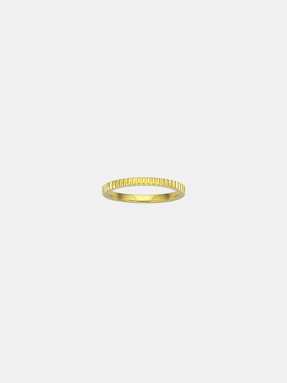 Gold ring on a light beige background